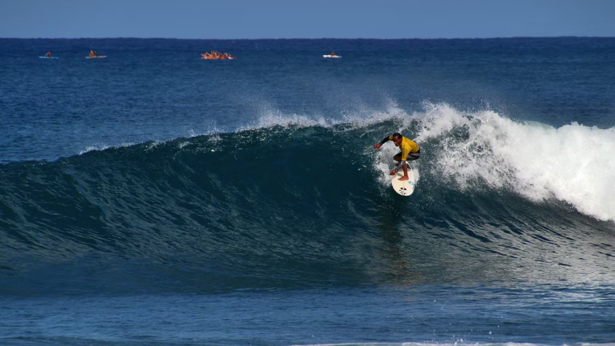 a man riding a wave on a surfboard in the ocean