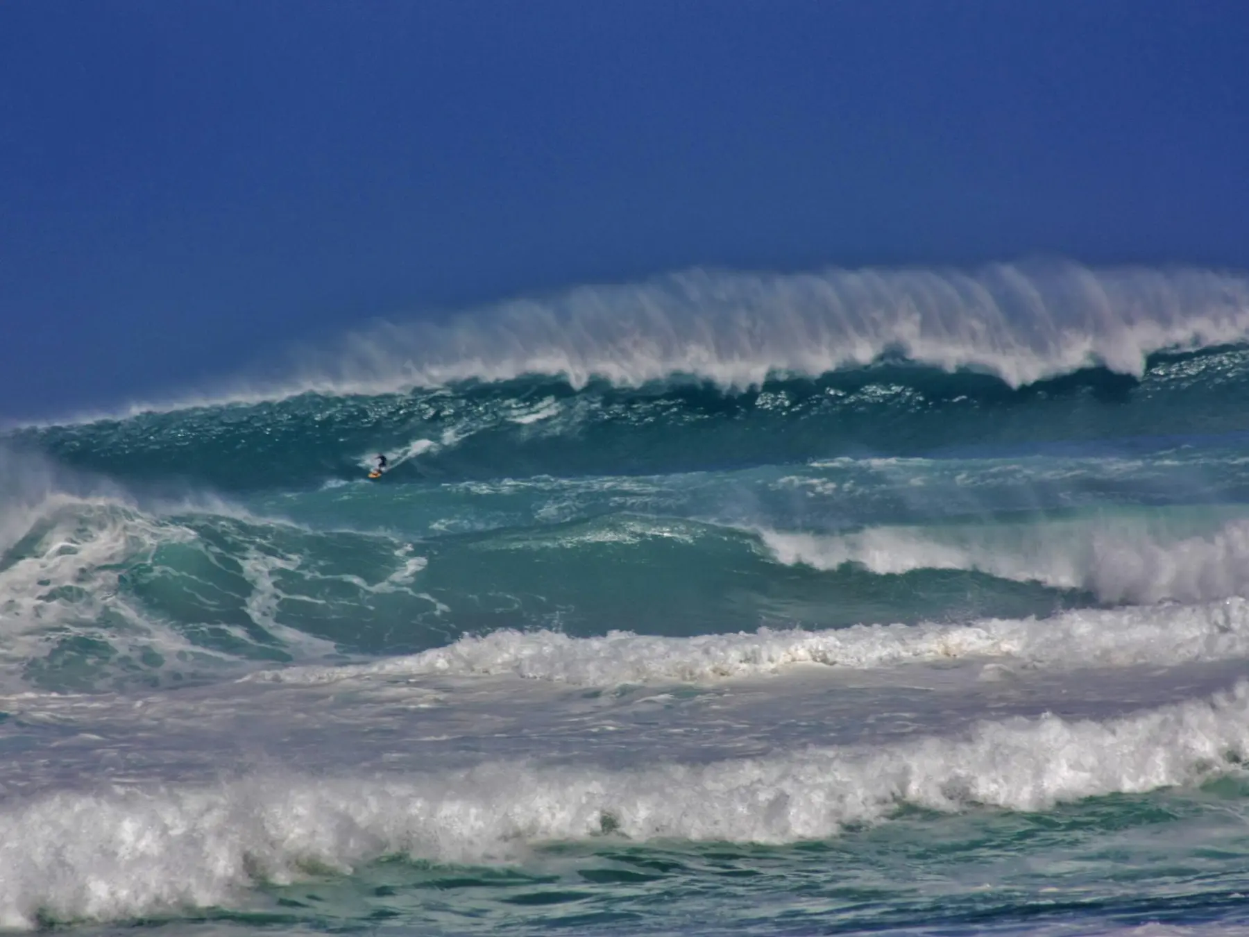 a man riding a wave on a surfboard in the ocean