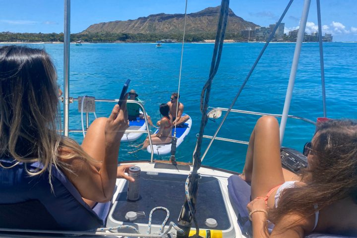 a group of people sitting in a boat on a body of water